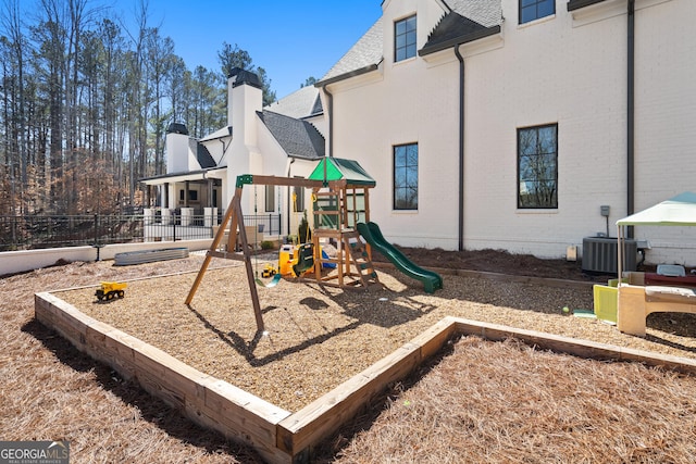 community play area with central AC unit and fence