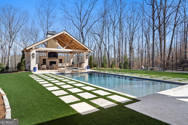 outdoor pool with a patio area, a yard, exterior fireplace, and a gazebo