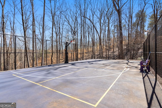 exterior space featuring community basketball court and fence