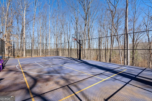 view of basketball court with community basketball court and fence