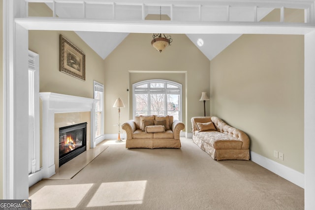 living room with light carpet, high vaulted ceiling, a fireplace, and baseboards