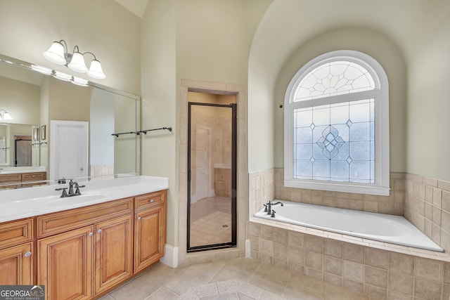 bathroom with a stall shower, vanity, a bath, and tile patterned floors