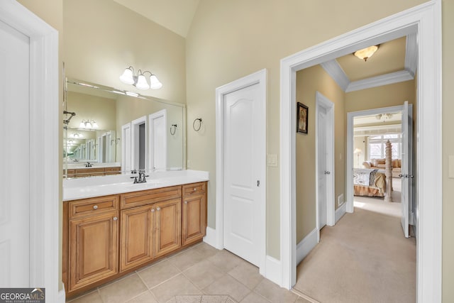 bathroom featuring crown molding, connected bathroom, vanity, tile patterned flooring, and baseboards