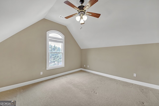 additional living space featuring light carpet, vaulted ceiling, visible vents, and baseboards