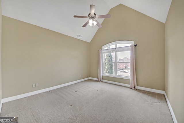 empty room featuring light carpet, baseboards, visible vents, ceiling fan, and high vaulted ceiling