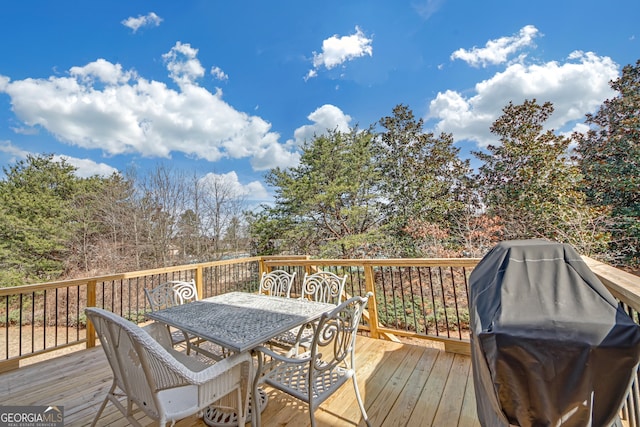 wooden terrace with grilling area and outdoor dining space