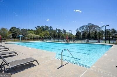 pool featuring a patio area and fence