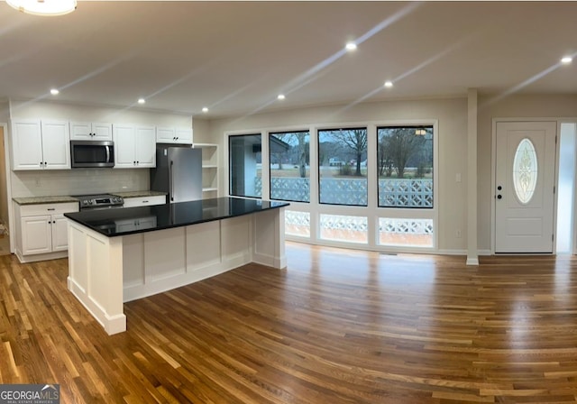 kitchen with backsplash, dark wood finished floors, white cabinetry, recessed lighting, and stainless steel appliances