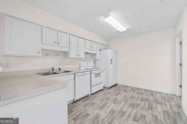 kitchen with under cabinet range hood, white appliances, a sink, white cabinetry, and light countertops