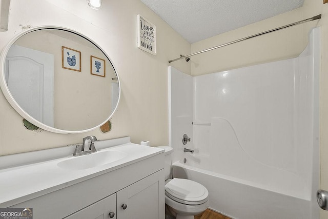 full bath featuring a textured ceiling, shower / bathtub combination, vanity, and toilet