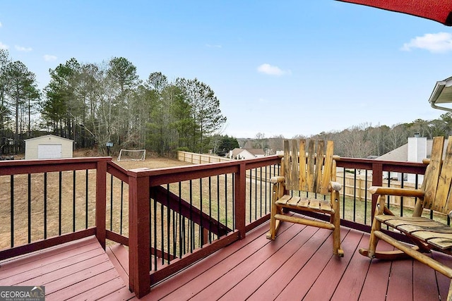 deck featuring a storage shed, an outdoor structure, and a detached garage