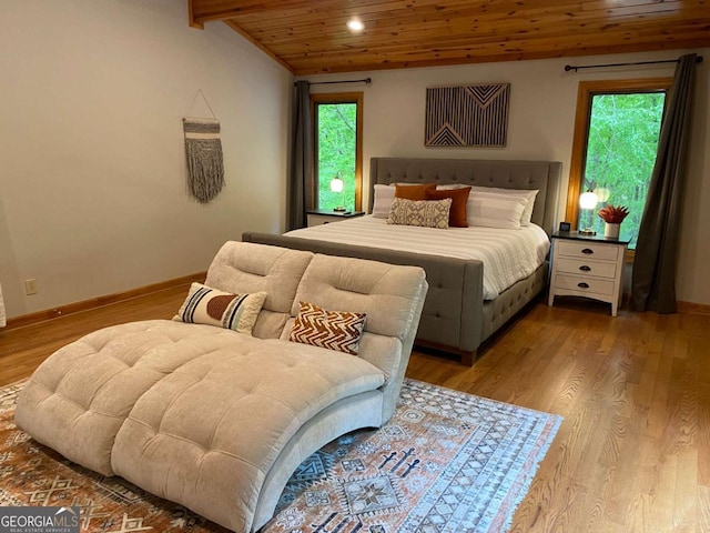 bedroom with lofted ceiling with beams, wooden ceiling, wood finished floors, and baseboards