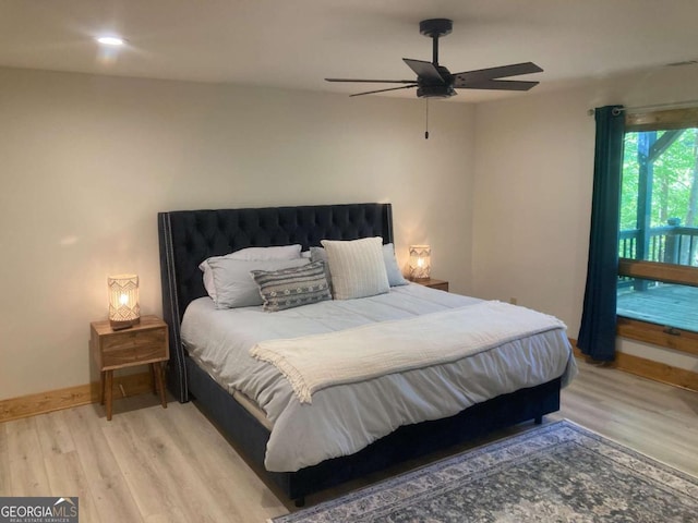 bedroom with a ceiling fan, baseboards, and light wood finished floors