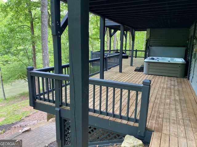 wooden terrace featuring a hot tub