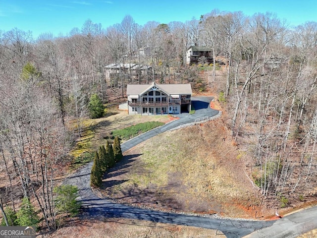 birds eye view of property with a view of trees