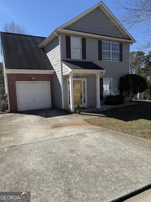 traditional-style house featuring driveway and an attached garage