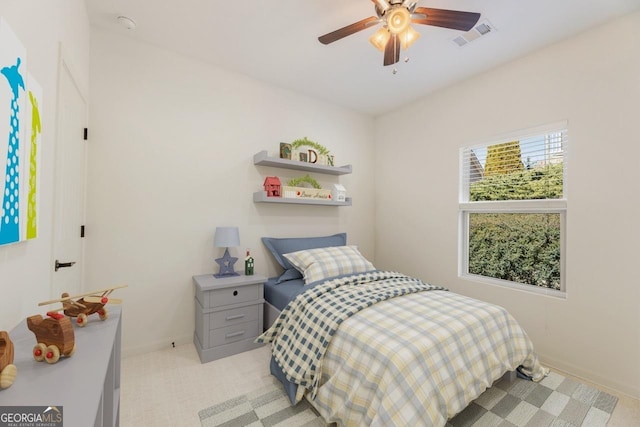 bedroom featuring a ceiling fan, light colored carpet, and visible vents