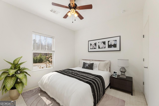 bedroom featuring a ceiling fan and visible vents