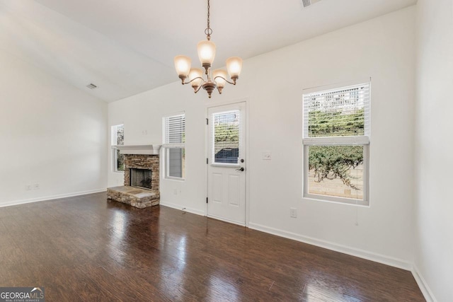 unfurnished living room with dark wood-style floors, visible vents, a stone fireplace, and baseboards