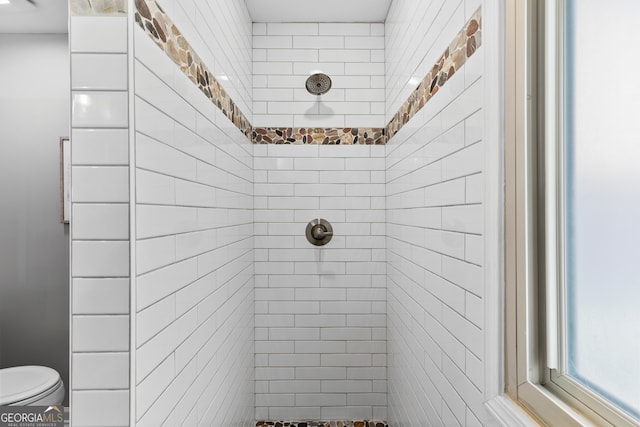 full bathroom with tiled shower