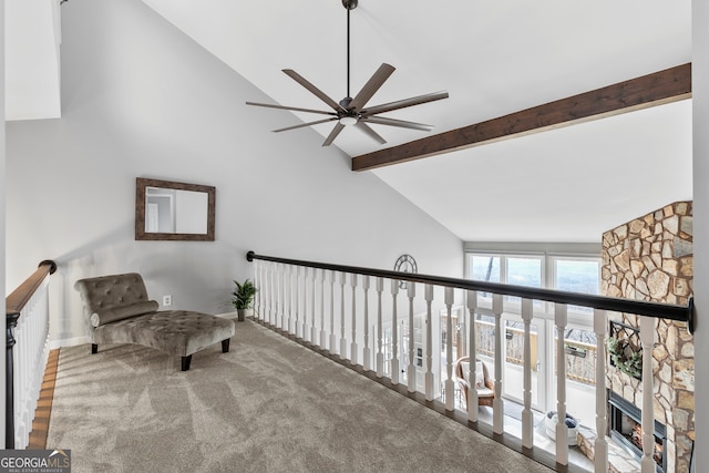 sitting room featuring high vaulted ceiling, beamed ceiling, carpet floors, and a fireplace