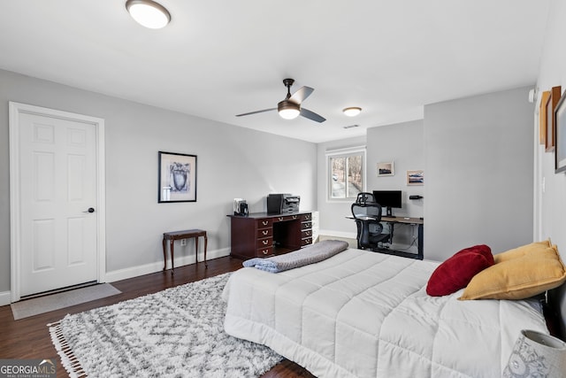 bedroom with dark wood-type flooring, visible vents, ceiling fan, and baseboards