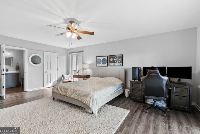 bedroom featuring dark wood-style floors, ensuite bath, baseboards, and ceiling fan