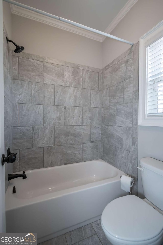 full bathroom featuring crown molding, bathing tub / shower combination, and toilet