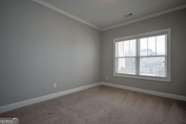 carpeted empty room featuring visible vents, crown molding, and baseboards