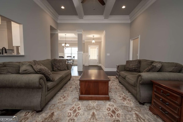 living room featuring light wood finished floors, beamed ceiling, coffered ceiling, and crown molding