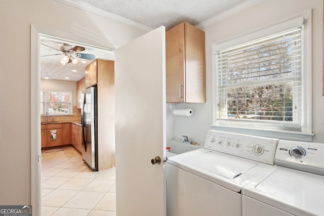 laundry room with light tile patterned floors, ceiling fan, a textured ceiling, a sink, and cabinet space