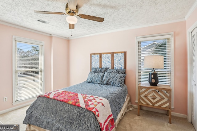 bedroom featuring crown molding, light colored carpet, visible vents, a textured ceiling, and baseboards