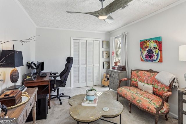 home office featuring a textured ceiling, a ceiling fan, crown molding, and light colored carpet