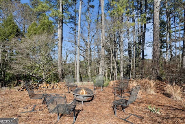 view of yard with a fire pit