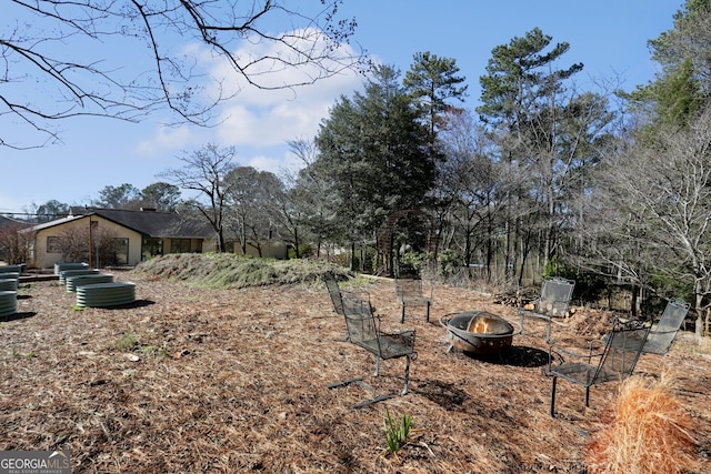 view of yard with an outdoor fire pit