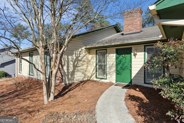 entrance to property featuring a chimney