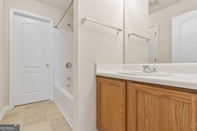 bathroom featuring visible vents, vanity, and shower / bathtub combination