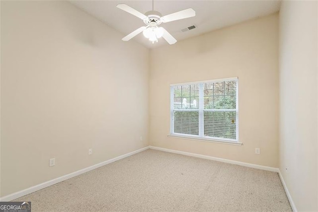 unfurnished room featuring visible vents, lofted ceiling, carpet, baseboards, and ceiling fan