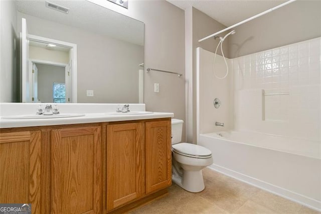 bathroom with visible vents, toilet, a sink,  shower combination, and double vanity