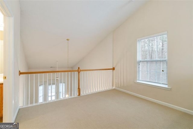 interior space with lofted ceiling, carpet flooring, and baseboards