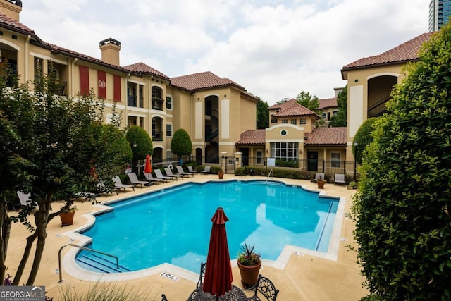 pool featuring a patio and fence