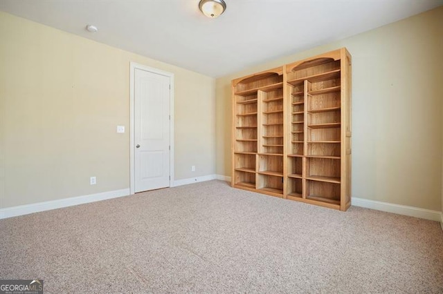 carpeted empty room with baseboards