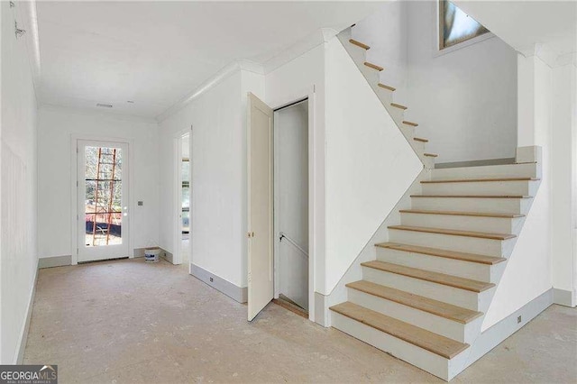 stairs featuring ornamental molding and baseboards