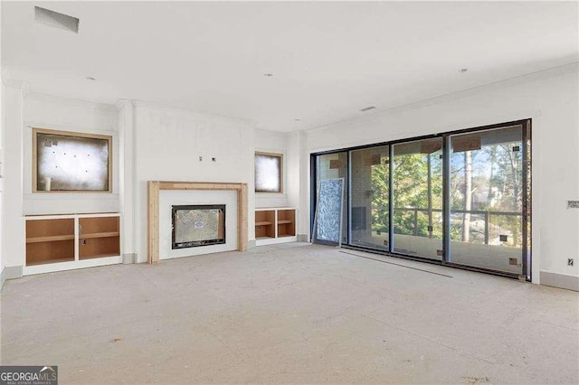 unfurnished living room with a fireplace and concrete flooring