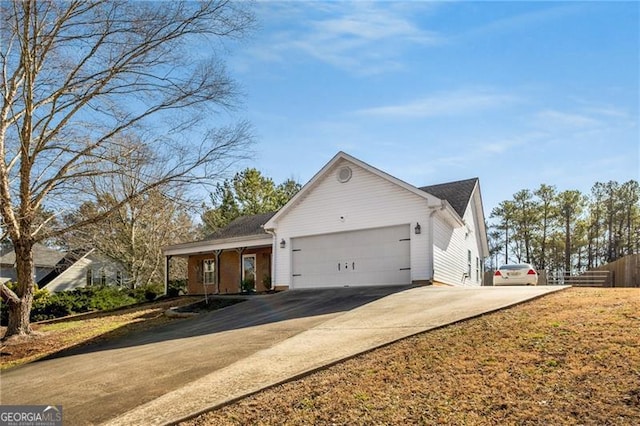 view of front of house featuring concrete driveway and an attached garage