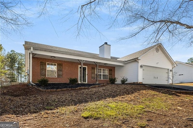 single story home with a porch, brick siding, a chimney, and an attached garage