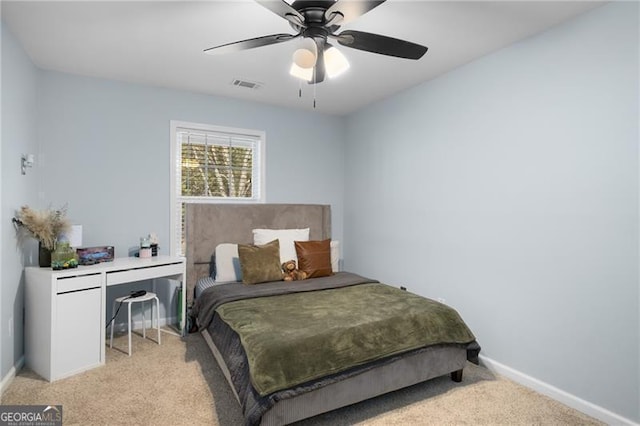 bedroom with baseboards, visible vents, a ceiling fan, and light colored carpet