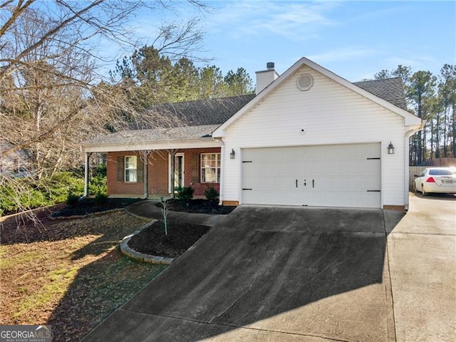 single story home with an attached garage, driveway, a chimney, and brick siding