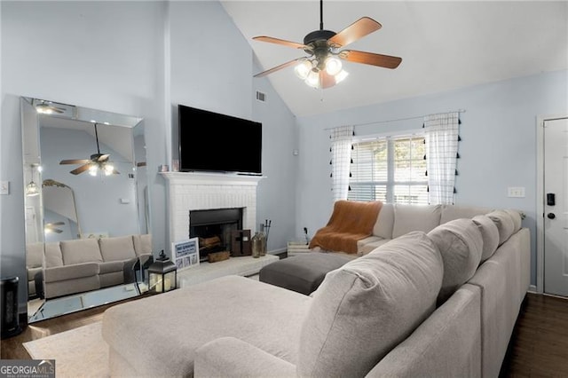 living room featuring ceiling fan, high vaulted ceiling, a fireplace, visible vents, and dark wood-style floors