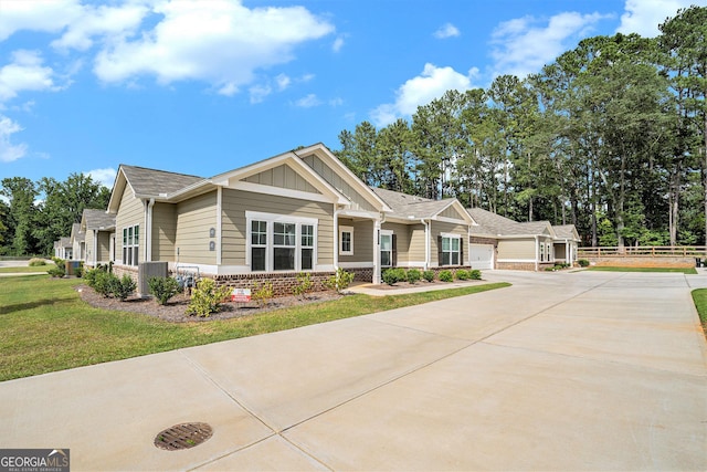 view of front facade featuring an attached garage, brick siding, concrete driveway, a front lawn, and board and batten siding